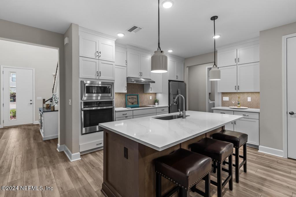 11232 Bright Path Jacksonville, FL 32256 - Photo 3 of 78 a open kitchen with stainless steel appliances granite countertop a stove a refrigerator a kitchen island a sink and a refrigerator