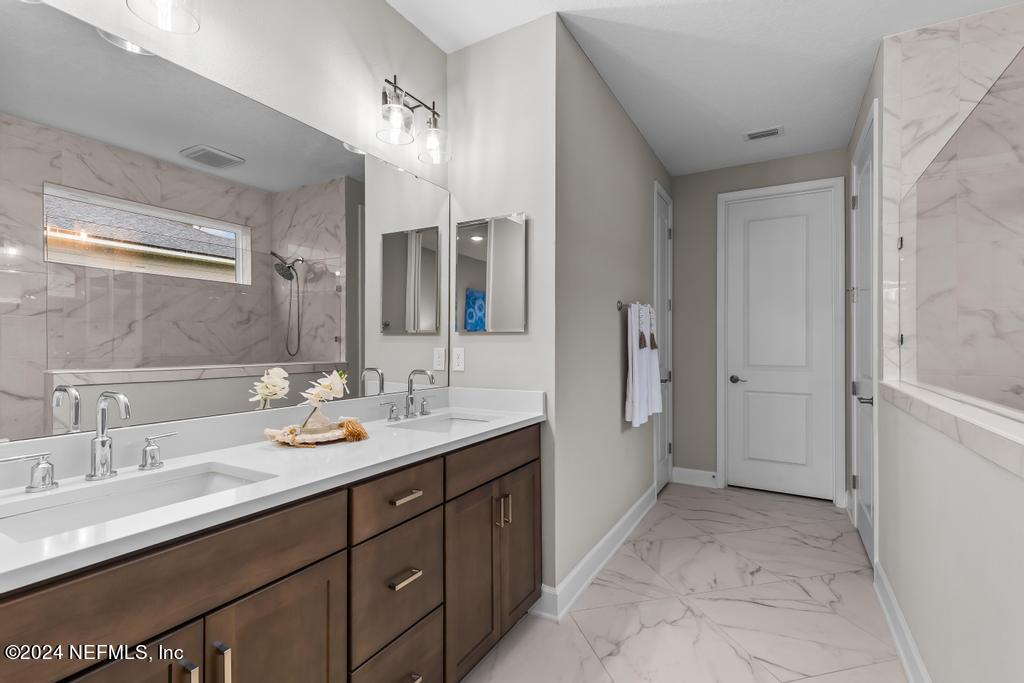 11232 Bright Path Jacksonville, FL 32256 - Photo 31 of 78 a spacious bathroom with a double vanity sink mirror double and shower