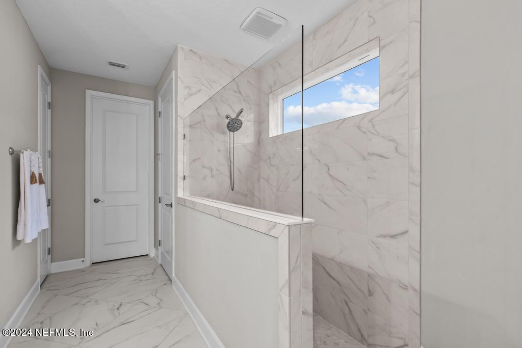 11232 Bright Path Jacksonville, FL 32256 - Photo 33 of 78 a bathroom with a glass shower door and a sink