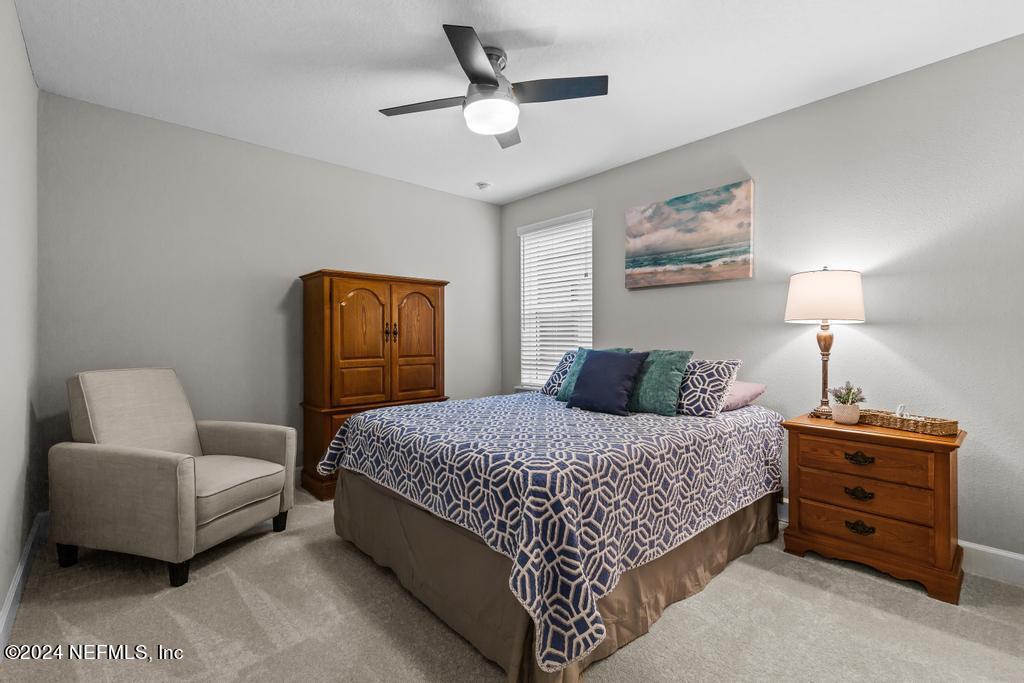 11232 Bright Path Jacksonville, FL 32256 - Photo 42 of 78 a bedroom with a bed and a couch