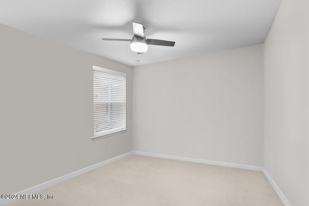 11232 Bright Path Jacksonville, FL 32256 - Photo 44 of 78 an empty room with a window and ceiling fan
