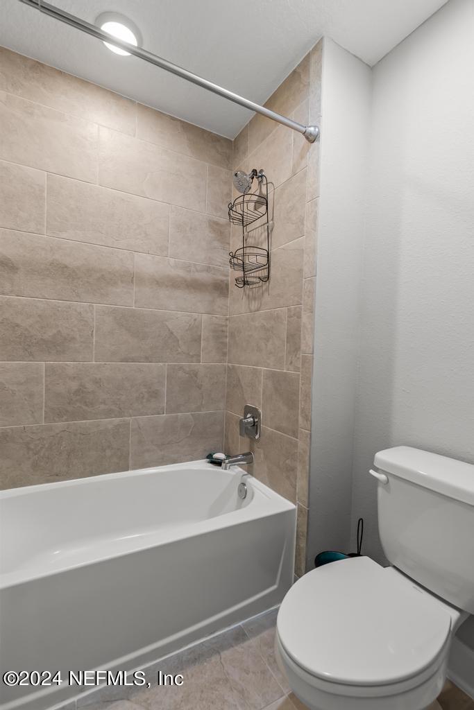 11232 Bright Path Jacksonville, FL 32256 - Photo 50 of 78 a white toilet sitting next to a bath tub and a shower