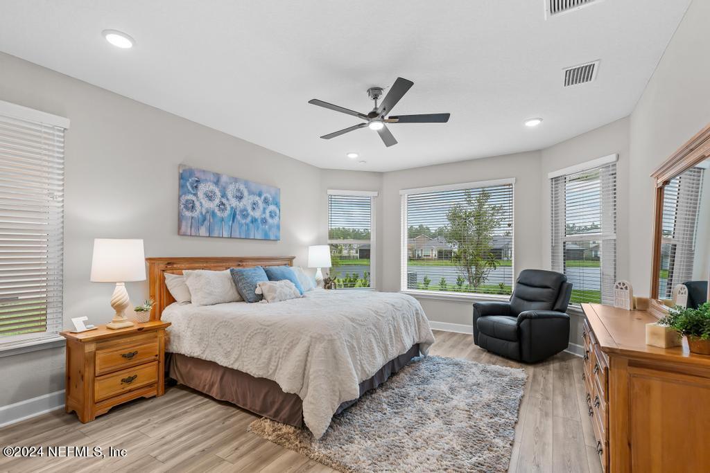 11232 Bright Path Jacksonville, FL 32256 - Photo 5 of 78 a bedroom with a bed couch and a large window