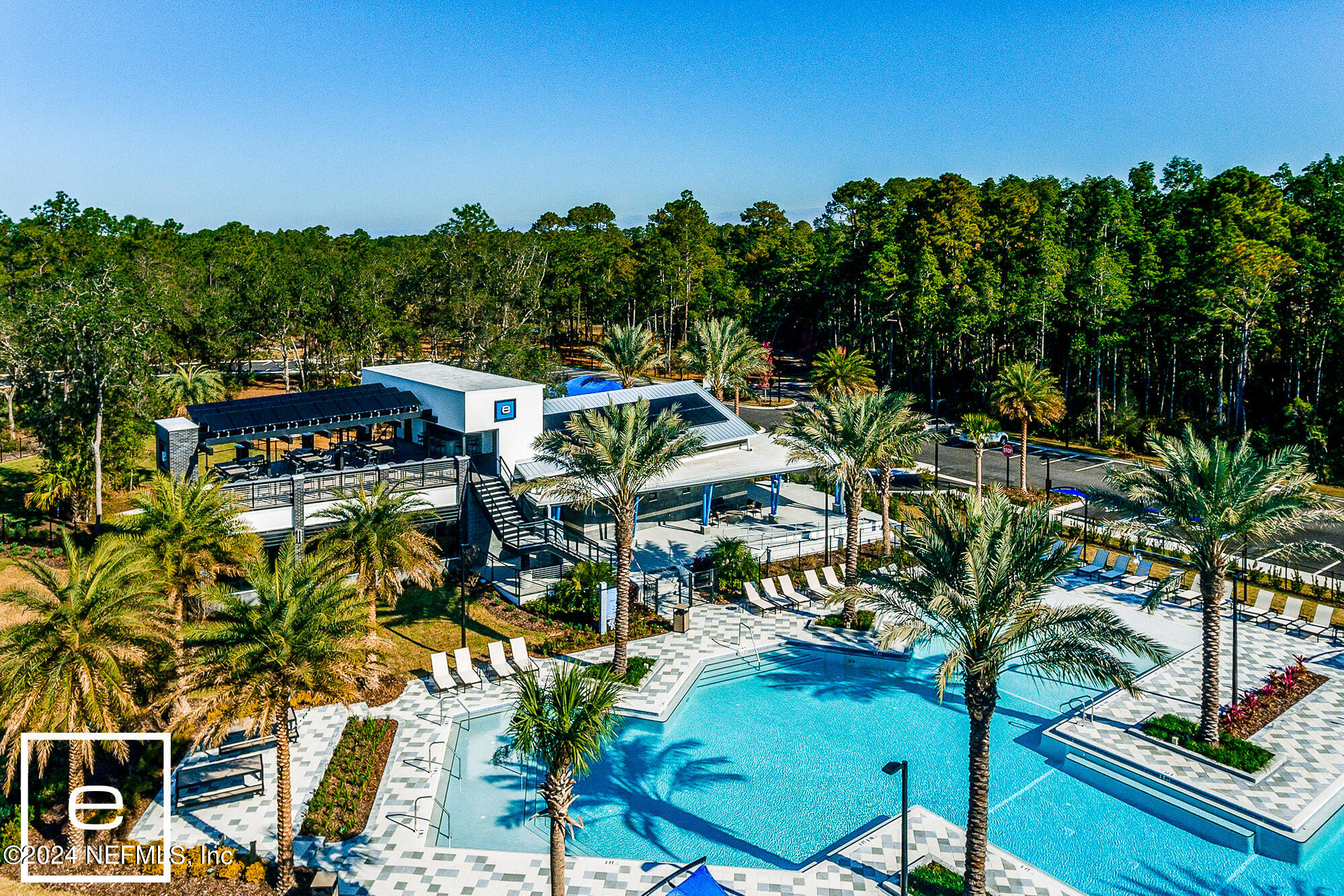11232 Bright Path Jacksonville, FL 32256 - Photo 72 of 78 a view of a swimming pool with lawn chairs under an umbrella