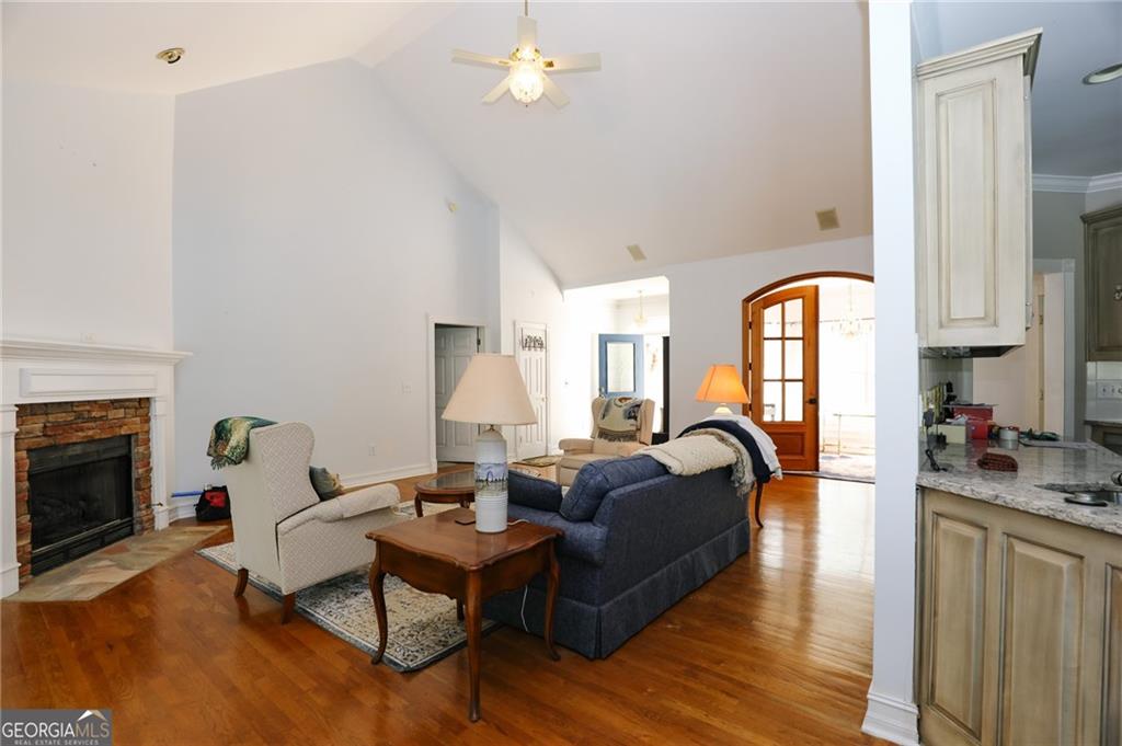 7404 Golfers Villa Rica, GA 30180 - Photo 8 of 43 a living room with furniture a fireplace and wooden floor