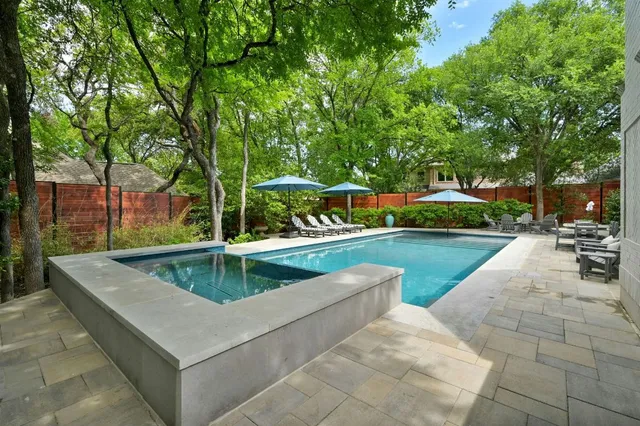 a view of backyard with swimming pool and outdoor seating