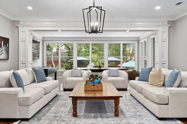 a dining room with furniture window and wooden floor