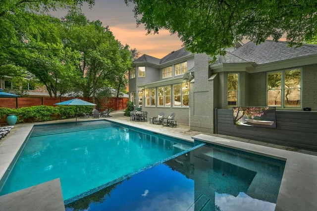a swimming pool view with a outdoor seating