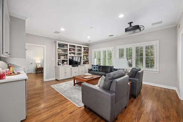 a view of swimming pool with lawn chairs and trees