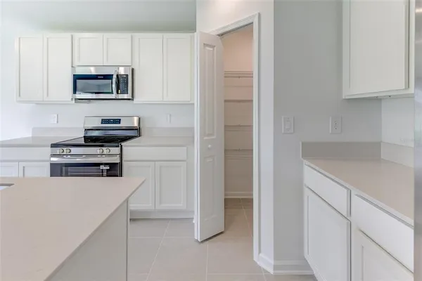 a kitchen with a refrigerator and cabinets