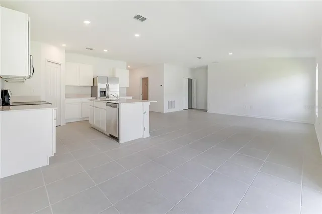 a view of kitchen with white cabinets stainless steel appliances