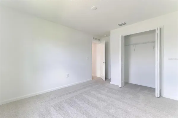 a bathroom with a sink a toilet and a large mirror