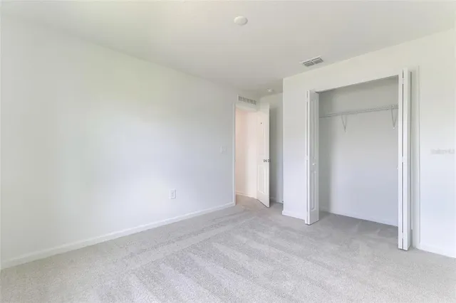 a bathroom with a sink a toilet and a large mirror