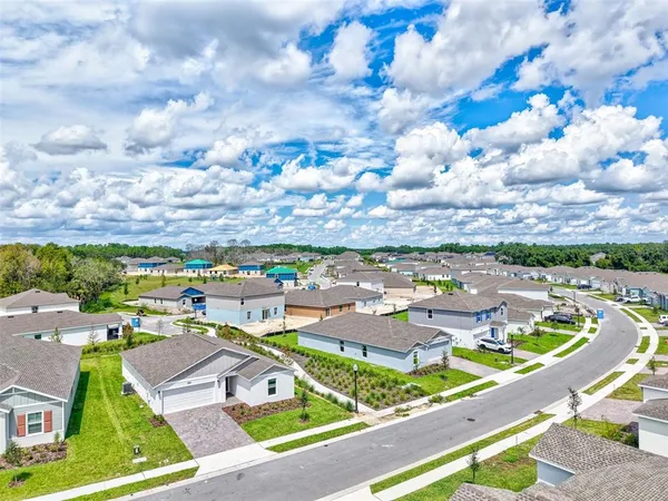 a view of yard with swimming pool and green space