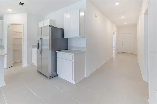 a view of a kitchen with a refrigerator and a sink