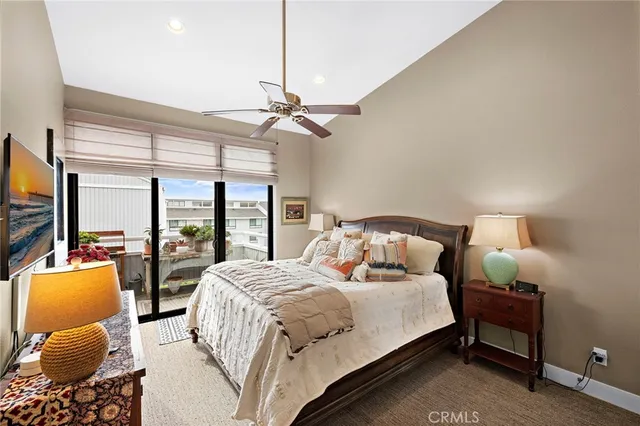 a bedroom with a bed and large windows