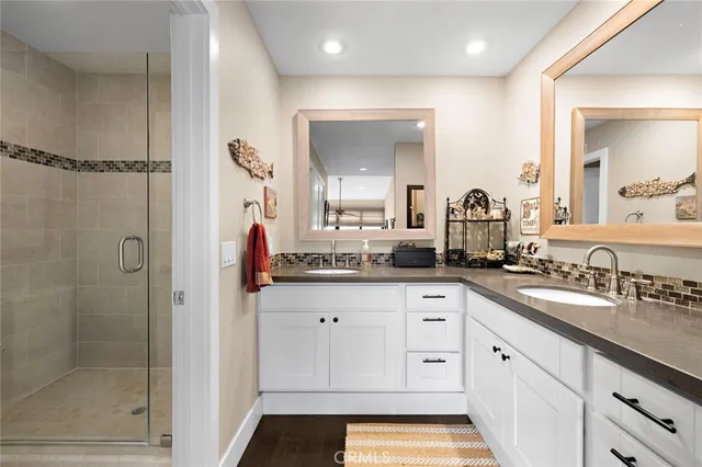 a spacious bathroom with a shower sink and mirror