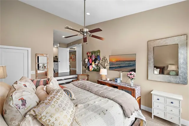 a bedroom with a large bed and a flat tv screen