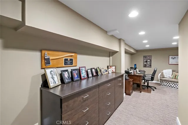 a room with furniture a bookshelf and a window