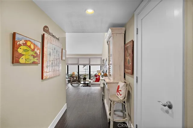 a view of a hallway with furniture and floor to ceiling window