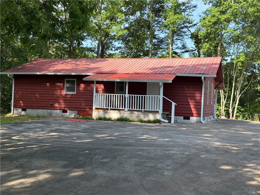 86 Robert Jones Road Dawsonville, GA 30534 - Photo 14 of 19 a front view of a house with a garden