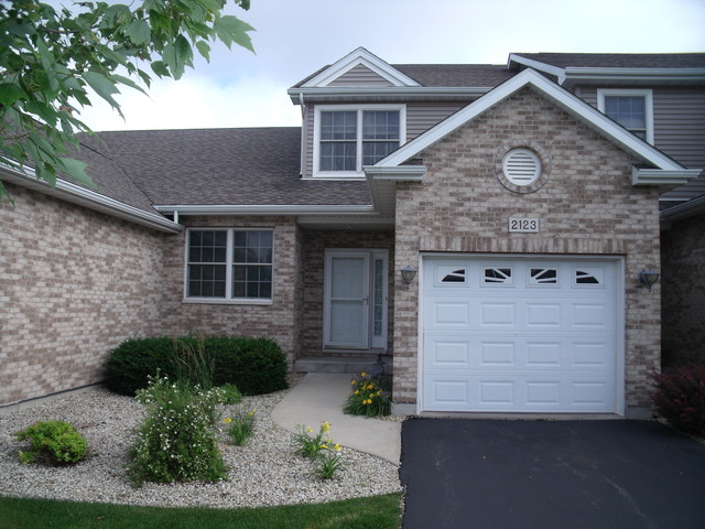 2123 Autumn Lane, Unit 2123 DeKalb, IL 60115 - Photo 1 of 12 a view of a brick house with large windows