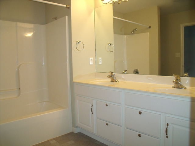 2123 Autumn Lane, Unit 2123 DeKalb, IL 60115 - Photo 7 of 12 a bathroom with a tub sink and mirror