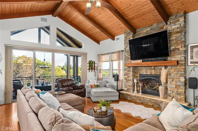 a living room with furniture a flat screen tv and a large window
