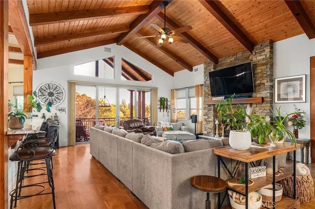 a kitchen with stainless steel appliances granite countertop a refrigerator a stove and a sink with wooden floor