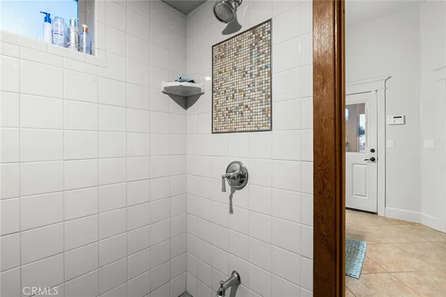 a living room with patio furniture and floor to ceiling windows