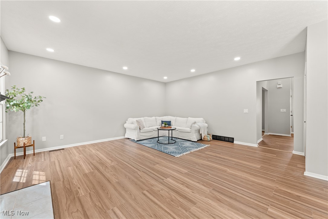 8080 Fair Road Strongsville, OH 44149 - Photo 9 of 50 Unfurnished living room featuring light wood-style floors, recessed lighting, and baseboards