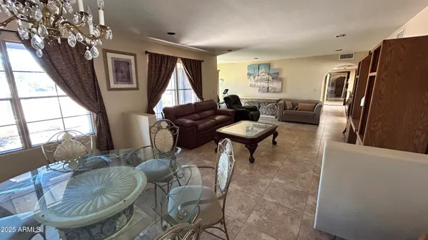 a living room with furniture a window and a dining table