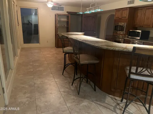 a kitchen with a table and chairs