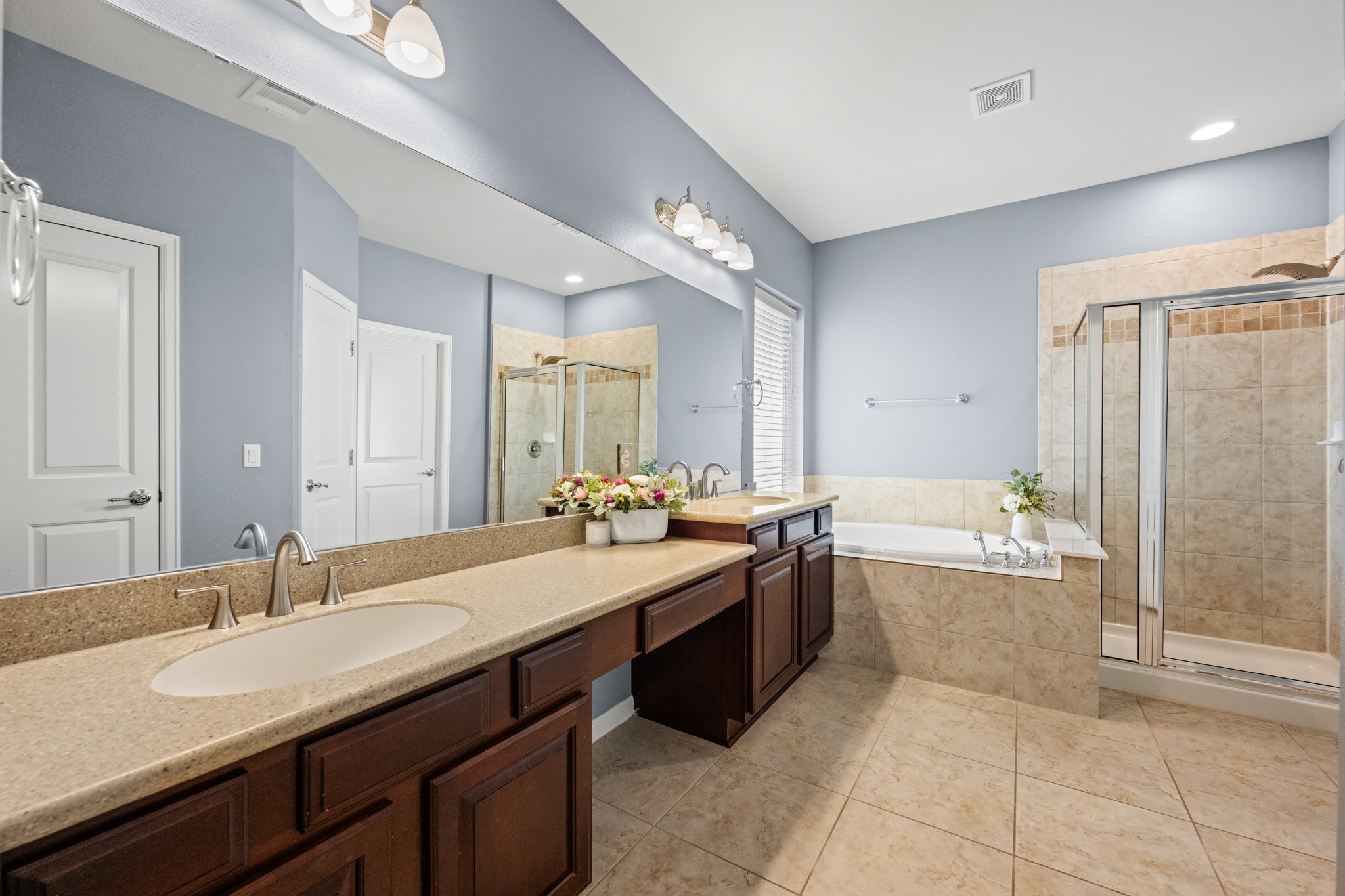 1023 Grassy Field Road Austin, TX 78737 - Photo 18 of 40 Primary bath including dual sink vanity, garden tub and separate glass-enclosed shower with tile surround.