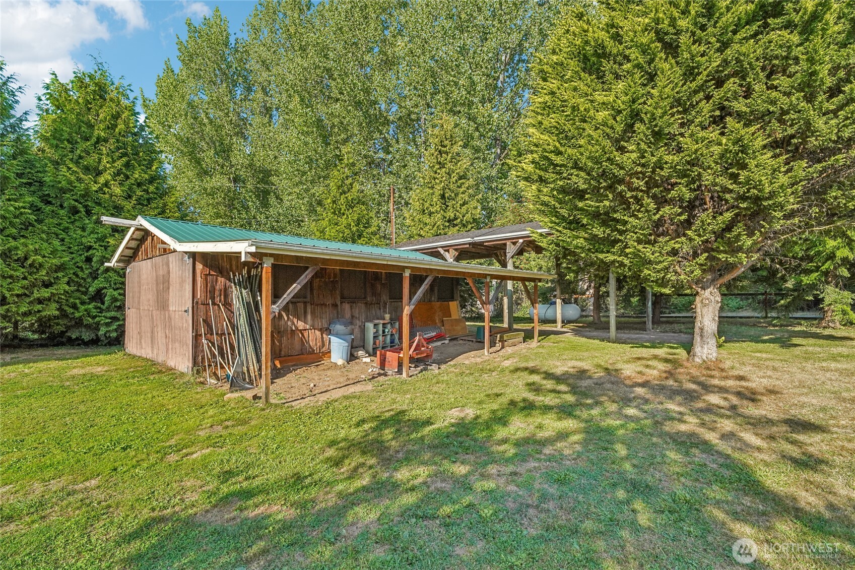 14827 Three Lakes Road Snohomish, WA 98290 - Photo 32 of 39 a view of a small house with a big yard and large trees