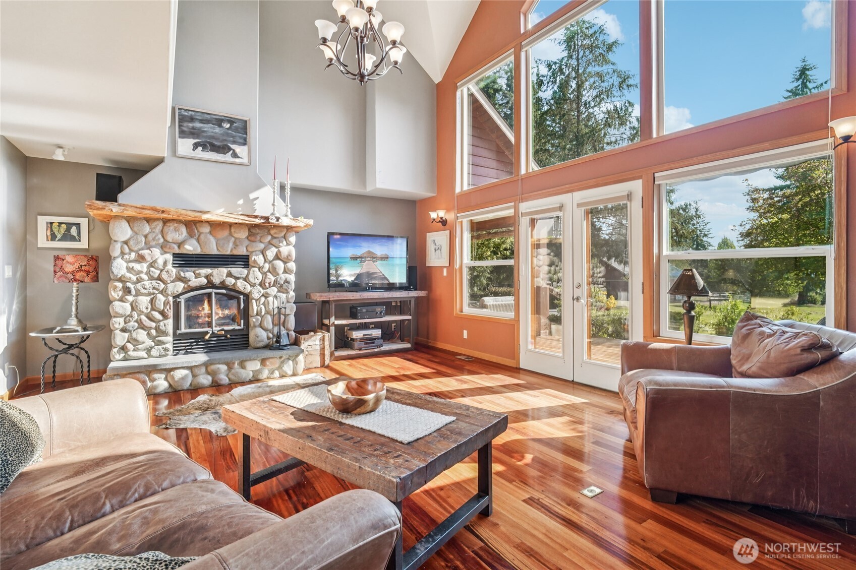 14827 Three Lakes Road Snohomish, WA 98290 - Photo 6 of 39 a living room with furniture a fireplace and a floor to ceiling window