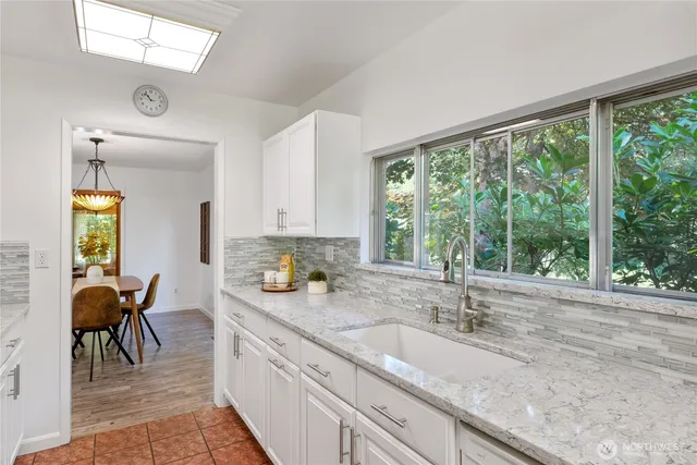 a kitchen with sink cabinets and dining table