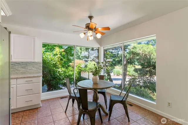 a dining room with furniture a chandelier and a window