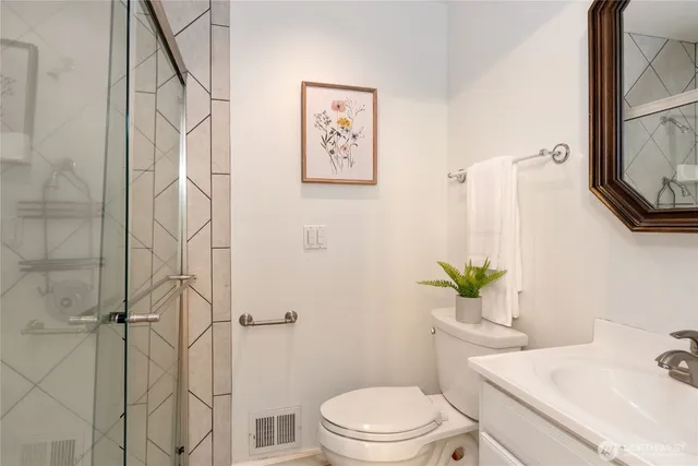 a white toilet sitting next to a bathroom sink