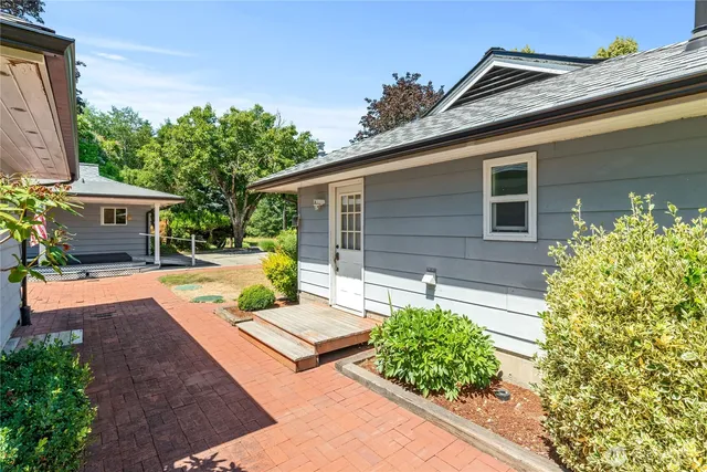 a view of house with backyard and a garden