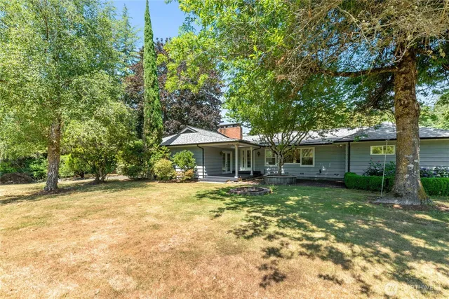 a backyard of a house with yard and outdoor seating