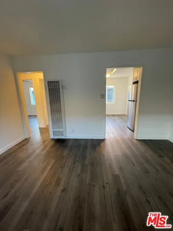 a view of a room with wooden floor and stairs