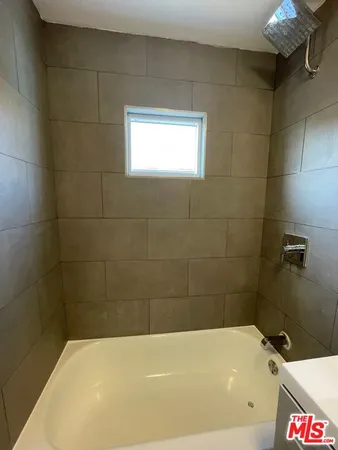 a bathroom with a bathtub and shower