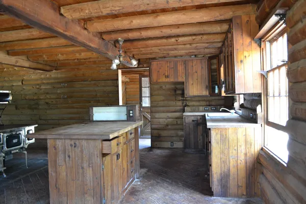 a bathroom with a granite countertop sink a mirror and shower