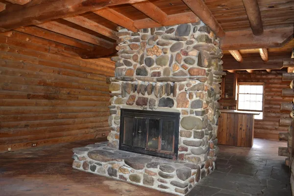 a kitchen with stainless steel appliances wooden floors stove top oven and cabinets