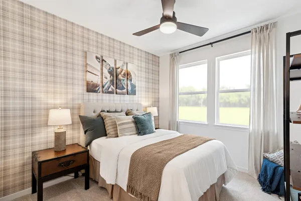 a bedroom with a bed and a painting on the wall