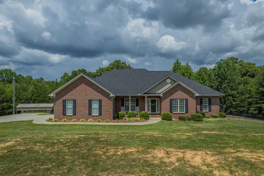 415 New Hope Road Toccoa, GA 30577 - Photo 1 of 1 a front view of a house with a garden