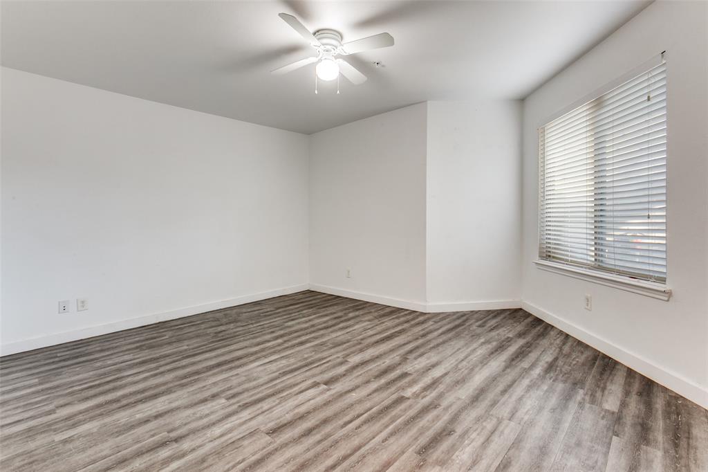 9829 Walnut Street, Unit 210 Dallas, TX 75243 - Photo 11 of 19 wooden floor in an empty room with a window
