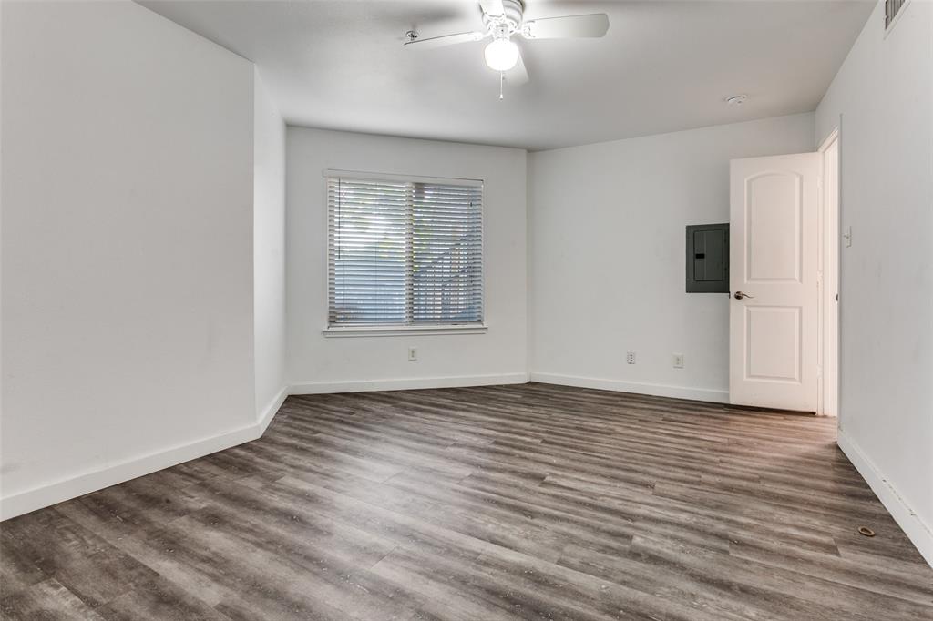 9829 Walnut Street, Unit 210 Dallas, TX 75243 - Photo 12 of 19 a view of an empty room with wooden floor and a window