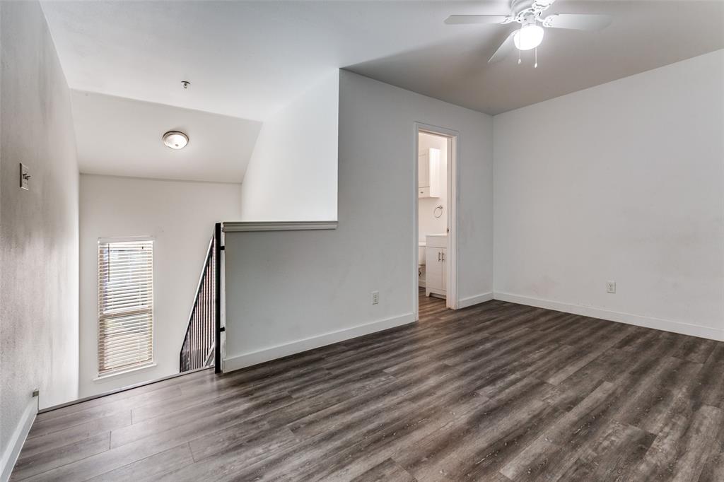 9829 Walnut Street, Unit 210 Dallas, TX 75243 - Photo 14 of 19 wooden floor in an empty room with a window